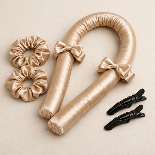 Heatless hair curling set with satin curling rod, scrunchies and black hair clips on beige background.